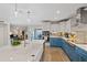 Well-appointed kitchen features blue lower cabinets, a large island, stainless steel appliances, and modern finishes at 3910 Doral Dr, Tampa, FL 33634