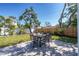 Backyard featuring a brick patio with a dining table set for six, a lush lawn, and mature landscaping at 4001 W North A St, Tampa, FL 33609