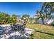 Backyard with brick patio, dining set for six, lush lawn, beautiful landscaping, and white privacy fence at 4001 W North A St, Tampa, FL 33609