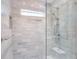 Modern bathroom featuring gray tiled walls, a glass shower with a dual shower head, and a small horizontal window at 4001 W North A St, Tampa, FL 33609