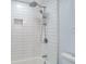 Bright bathroom featuring a tub and shower with white tiling, and chrome fixtures at 4001 W North A St, Tampa, FL 33609