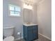 Bright bathroom featuring a blue vanity with marble top and bronze fixtures at 4001 W North A St, Tampa, FL 33609