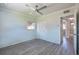 A light bedroom with gray wood floors, a ceiling fan, a closet, and a connecting door to another room at 4001 W North A St, Tampa, FL 33609