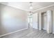 A bedroom with gray wood flooring, an open closet, and a view to other rooms, highlighting the open floor plan at 4001 W North A St, Tampa, FL 33609