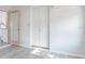 Bedroom with closet and open door to living space featuring a gray wood floor at 4001 W North A St, Tampa, FL 33609
