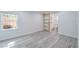 Bedroom with door to bathroom and window featuring a gray wood floor at 4001 W North A St, Tampa, FL 33609