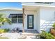 Well-manicured front entrance with black-framed glass door and tropical landscaping at 4001 W North A St, Tampa, FL 33609