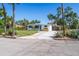 Well-maintained front exterior with mature tropical landscaping, gravel parking pad, and a concrete driveway at 4001 W North A St, Tampa, FL 33609