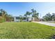 Well-manicured lawn with mature trees highlight the home's exterior at 4001 W North A St, Tampa, FL 33609