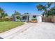 Neat single-story home featuring a manicured lawn and a mix of concrete and gravel driveway at 4001 W North A St, Tampa, FL 33609