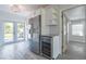 Bright kitchen featuring white cabinets, modern appliances, and granite countertops with gray wood floor at 4001 W North A St, Tampa, FL 33609