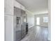 Bright kitchen featuring white cabinets, modern appliances, and granite countertops with gray wood floor at 4001 W North A St, Tampa, FL 33609