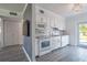 Bright kitchen featuring white cabinets, modern appliances, and granite countertops with gray wood floor at 4001 W North A St, Tampa, FL 33609