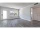 Open living room featuring modern gray flooring, a bright window, and white trim at 4001 W North A St, Tampa, FL 33609