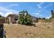 View of fenced backyard with mature tropical landscaping and a covered grill at 4017 3Rd E Ave, Bradenton, FL 34208