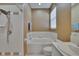 Well-lit bathroom with a shower, tub, and modern fixtures at 4017 3Rd E Ave, Bradenton, FL 34208
