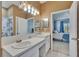Bright bathroom with a double vanity and a mirror view into a bedroom at 4017 3Rd E Ave, Bradenton, FL 34208