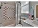 Bathroom features a shower-tub combo, a decorative shower curtain, and vanity with a solid surface countertop at 4017 3Rd E Ave, Bradenton, FL 34208