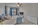 Bright bedroom features a ceiling fan, plush carpeting, and a window with backyard pool views at 4017 3Rd E Ave, Bradenton, FL 34208