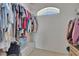 Walk-in closet with organized storage and natural light from an arched window at 4017 3Rd E Ave, Bradenton, FL 34208