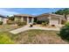 Inviting home exterior showcasing a neatly landscaped yard with a curved walkway leading to the front door at 4017 3Rd E Ave, Bradenton, FL 34208