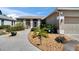 Charming home with well-maintained landscaping, including a stone walkway, mulch beds, and mature plants at 4017 3Rd E Ave, Bradenton, FL 34208