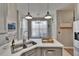 Modern kitchen features gray cabinetry, stainless steel appliances, and ample counter space at 4017 3Rd E Ave, Bradenton, FL 34208