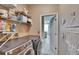 Functional laundry room with shelving for storage and modern washer and dryer at 4017 3Rd E Ave, Bradenton, FL 34208