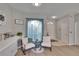 Sunlit sitting area with cozy chairs and an archway leading to the entry at 4017 3Rd E Ave, Bradenton, FL 34208