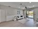 A bright living room features sleek flooring, modern decor, and a view of the outdoor pool area at 4017 3Rd E Ave, Bradenton, FL 34208
