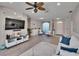 Bright living room features wood floors, ceiling fan, and entertainment center at 4017 3Rd E Ave, Bradenton, FL 34208