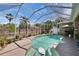 Sparkling pool enclosed by a screen, complemented by lush landscaping for a tranquil outdoor living experience at 4017 3Rd E Ave, Bradenton, FL 34208