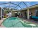 Outdoor pool area with screened-in enclosure and patio furniture, perfect for relaxation at 4017 3Rd E Ave, Bradenton, FL 34208