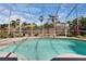Screened-in pool offering a relaxing retreat with clear water and lush tropical landscaping at 4017 3Rd E Ave, Bradenton, FL 34208