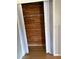 View of closet with wood paneled interior and white sliding doors at 4031 Chesswood Dr, Holiday, FL 34691