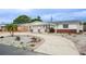 Cozy one-story home with white facade, a one-car garage, and a driveway lined with decorative rock at 4031 Chesswood Dr, Holiday, FL 34691