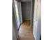 Hallway featuring hardwood floors, closet, sliding glass doors to outdoors and grey walls at 4031 Chesswood Dr, Holiday, FL 34691