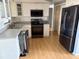 Modern kitchen with stainless steel appliances, light wood floors, and sleek cabinets for a minimalist feel at 4031 Chesswood Dr, Holiday, FL 34691