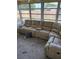 Bright living room featuring large beige couch and big windows at 4031 Chesswood Dr, Holiday, FL 34691