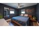 Modern bedroom featuring a ceiling fan and a decorative map wall hanging at 4311 W Oklahoma Ave, Tampa, FL 33616