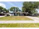 Charming single-story home featuring a carport, a well-manicured lawn and fresh, modern paint at 4311 W Oklahoma Ave, Tampa, FL 33616