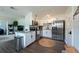 Contemporary kitchen with stainless steel appliances, granite countertops, and seamless flow into the living area at 4311 W Oklahoma Ave, Tampa, FL 33616