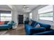 Inviting secondary sitting area with a comfortable blue sofa and plenty of natural light from the large windows at 4311 W Oklahoma Ave, Tampa, FL 33616
