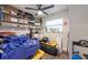 Organized room featuring shelving with storage, window, and ceiling fan at 4311 W Oklahoma Ave, Tampa, FL 33616