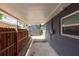 A spacious side yard featuring a covered walkway and a wooden fence for privacy and charm at 4311 W Oklahoma Ave, Tampa, FL 33616