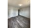 A well-lit bedroom with wood-look floors, neutral paint, and two closets with white doors at 4410 19Th N St, St Petersburg, FL 33714