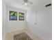 Neutral bedroom with tiled floor and two windows at 4410 19Th N St, St Petersburg, FL 33714