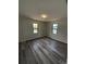Sunlit room with modern flooring, fresh paint, and two windows providing natural light at 4410 19Th N St, St Petersburg, FL 33714