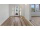 Bright foyer featuring wood-look flooring and a front door with decorative glass sidelights at 4410 19Th N St, St Petersburg, FL 33714