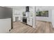 Modern kitchen featuring white cabinets, stainless steel appliances, and wood-look flooring at 4410 19Th N St, St Petersburg, FL 33714